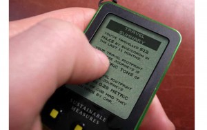 Hand holding a smart device showing a travel summary
