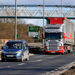 Picture of a lorry and a car driving on a motorway