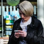Rail passenger checking phone at station