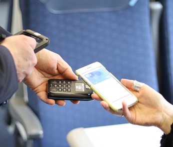 Passenger paying for a ticket on their phone.