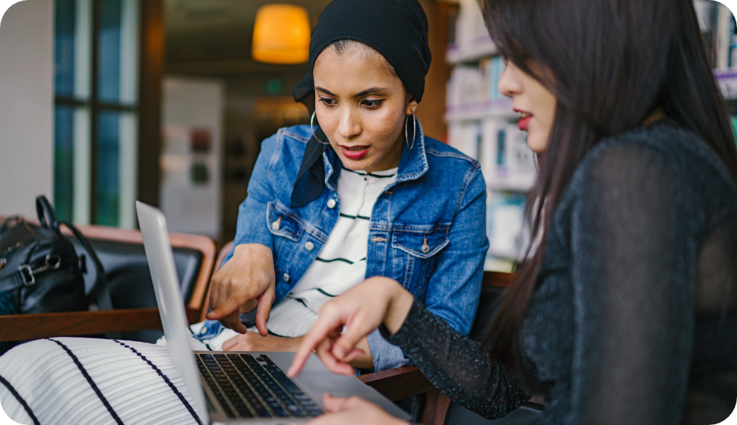 Two people looking at a laptop together.