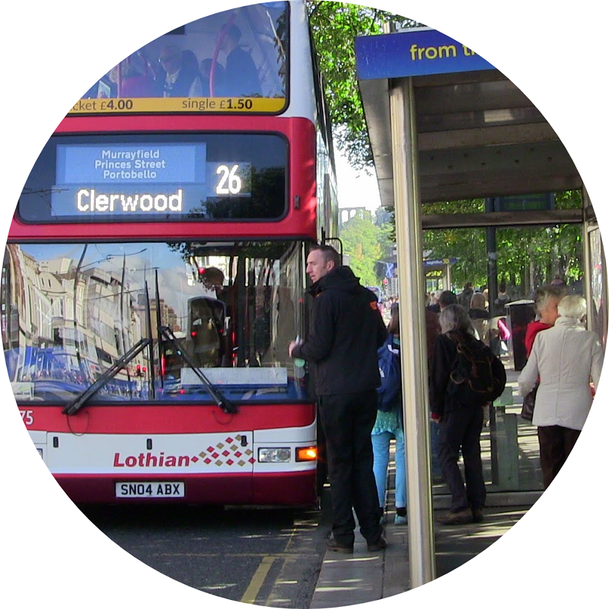 man at Edinburgh bus stop with bus waiting