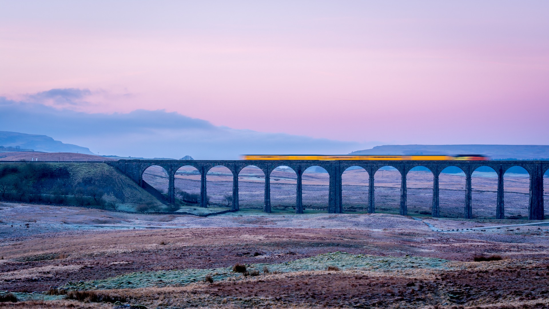 A train runs across a viaduct in the Yorkshire Dales