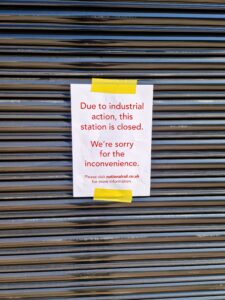 closed station shutter with notice about strikes taped on