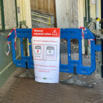 Station entrance blocked with plastic barrier which has a prominent sign on it