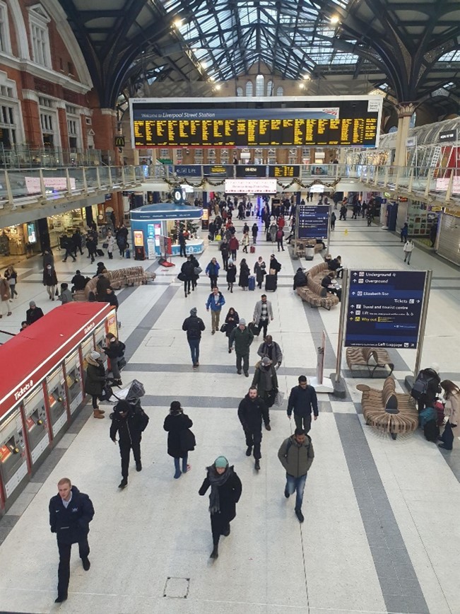 Liverpool Street station from an upper level - lots of passengers visible on concourse